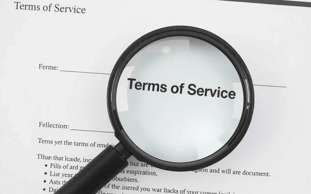 Pureenia legal document with a magnifying glass symbolizing careful review of terms.